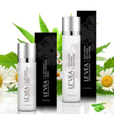 LE'VEA Age Perfect anti-aging treatment with night cream and vitamin C serum surrounded by green leaves.